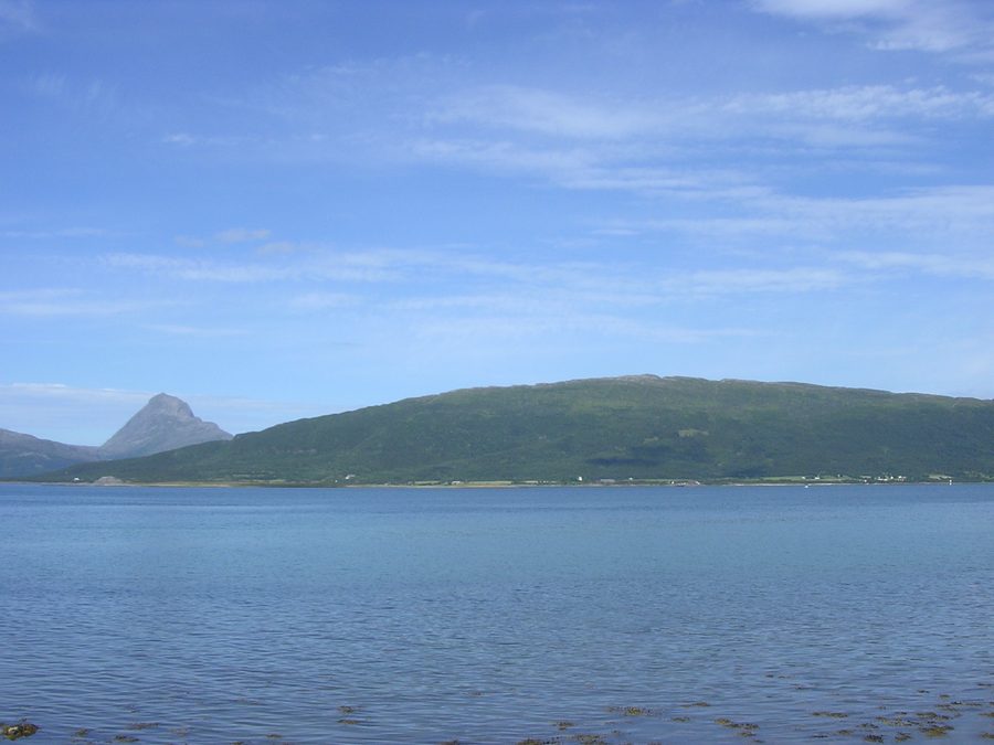 Handnesøya dans la commune de Nesna, vue depuis Nesna, avec la montagne Tomskjeveln sur l’île de Tomma en arrière-plan.